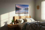 Alpenglow Beach Reverie beach canvas wall art displayed above a bed in a styled bedroom scene