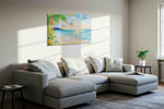 Heliconia Dawn Serenade beach canvas wall art displayed above a sofa in a styled living room scene