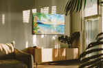 Heliconia Dawn Serenade beach canvas wall art displayed above a sofa in a modern living room