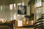 Under the Omens of Stars fantasy canvas wall art displayed above a sofa in a modern living room