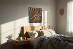 Prismatic Echo Arches geometric canvas wall art displayed above a bed in a styled bedroom scene