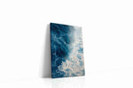 Where Foam Meets Midnight coastal canvas wall art displayed above a sofa in a modern living room