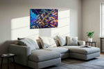 Neon Reef Rhapsody sea life canvas wall art displayed above a bed in a contemporary bedroom